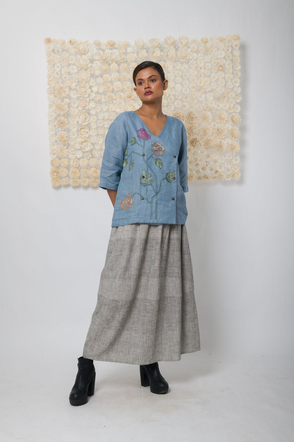 Powder blue floral appliqué V-neck top, front view