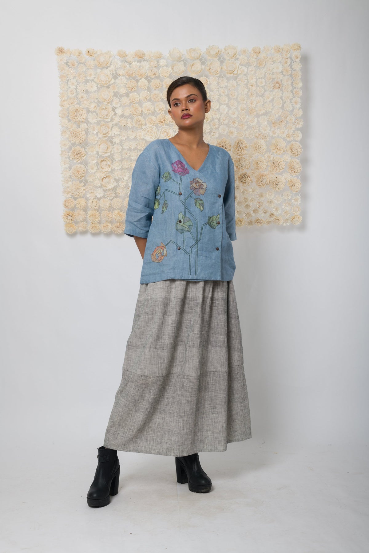 Powder blue floral appliqué V-neck top, front view