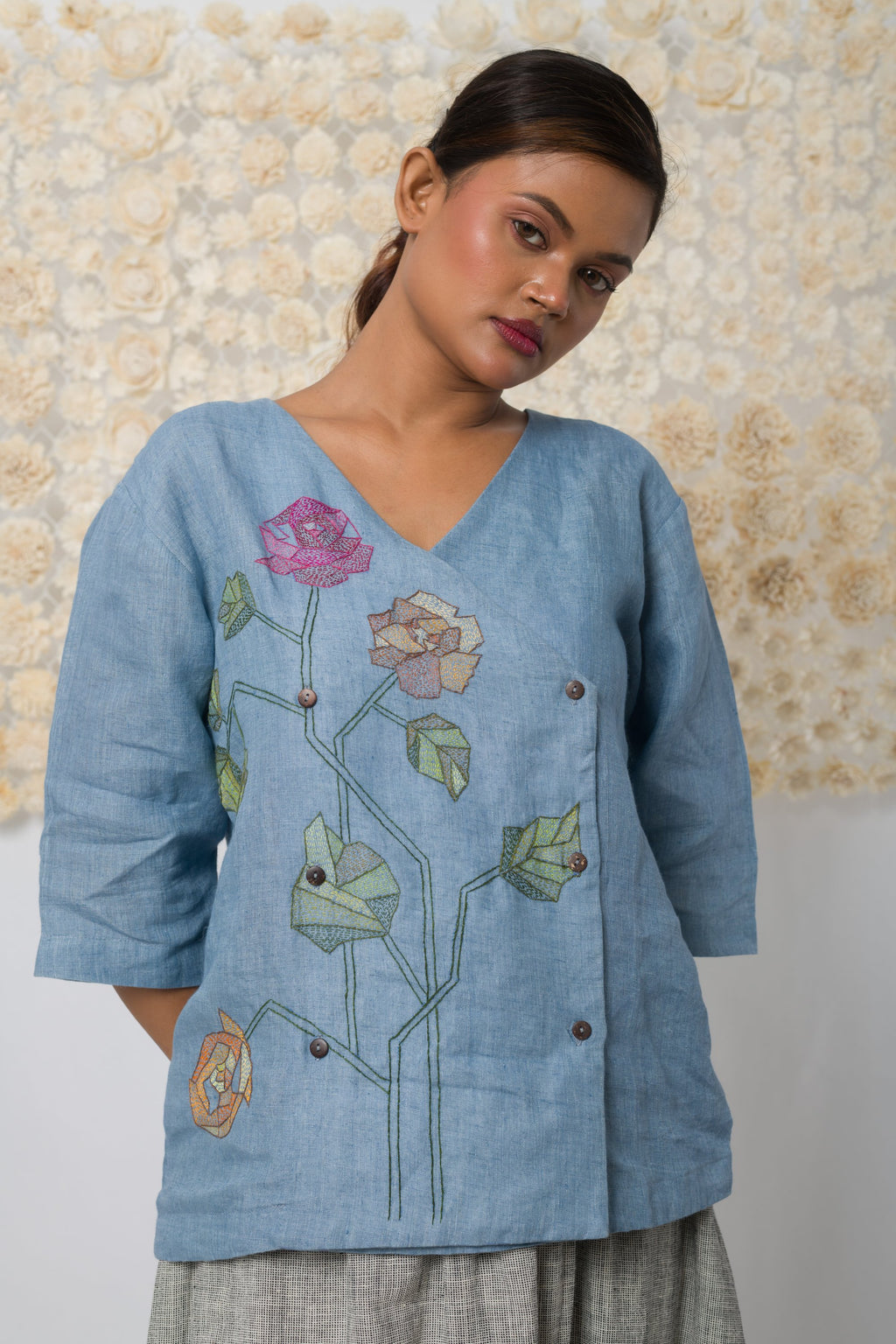 Powder blue floral appliqué V-neck top, full-length view