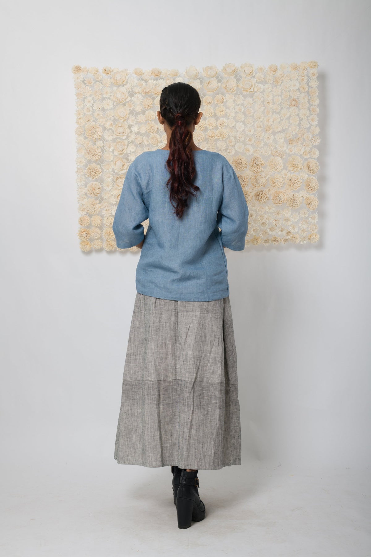 Powder blue floral appliqué V-neck top, back view with grey skirt